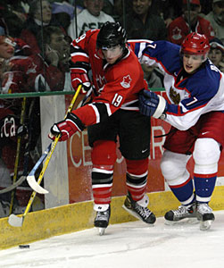 Canada's Andrew Ladd battles for the puck with Russia's Yakov Rylov during gold medal game action at the 2005 World Junior Championship in Fargo, North Dakota.