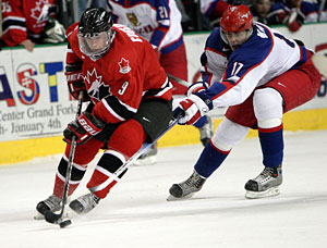 Canada's Sidney Crosby is checked by future teammate, Evgeni Malkin, during gold medal game action at the 2005 World Junior Championship in Fargo, North Dakota.
