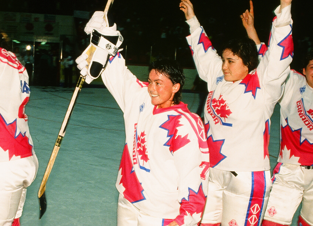Shirley Cameron (centre) and Vicky Sunohara (right) salute the crowd after winning the 1990 IIHF Ice Hockey Women's World Championship with Team Canada. Credit: Claus Anderson